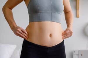 Does the Fat Come Back After Liposuction? 1 woman holding her love handles